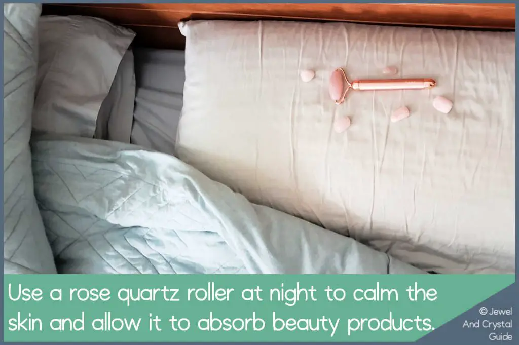 Photo of a rose quartz roller on a bed pillow
