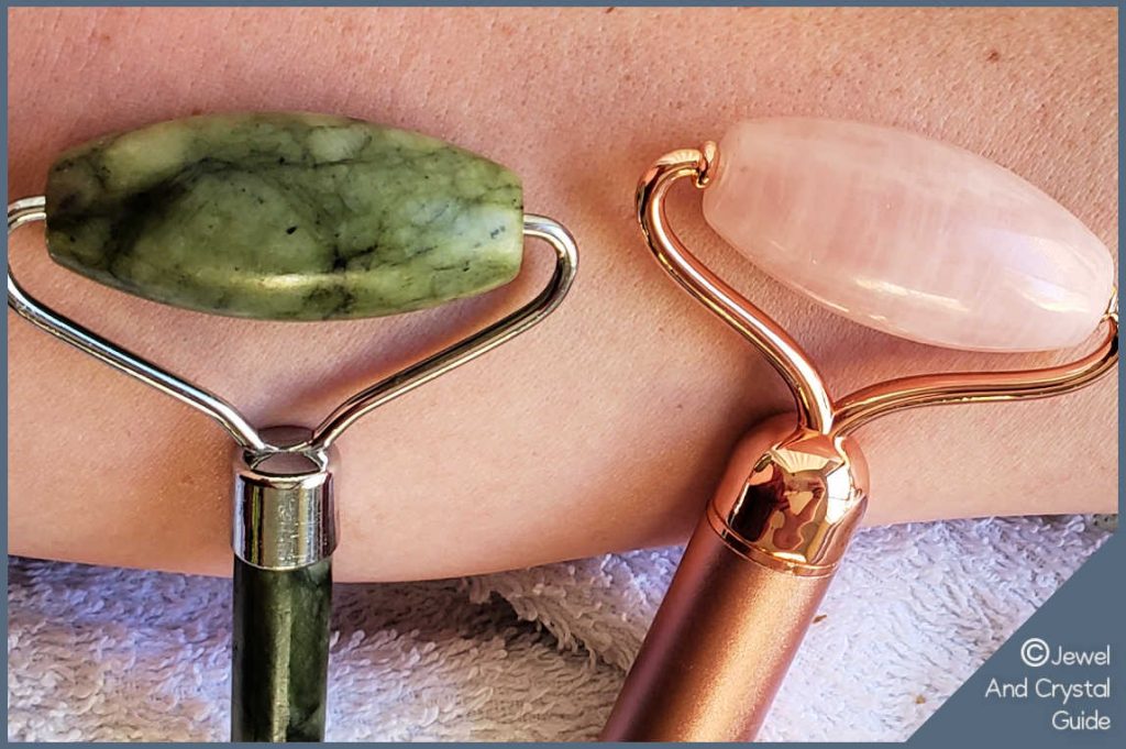 Photo of a jade roller and a rose quartz roller lying side by side on skin