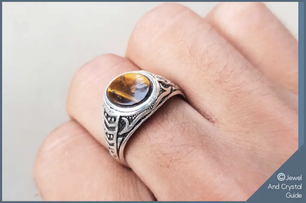 Photo of a tiger's eye ring on a finger