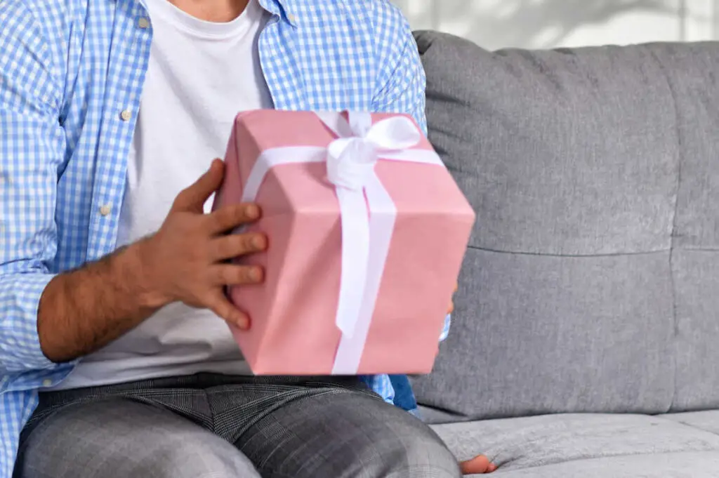 Man holding a pink gift box