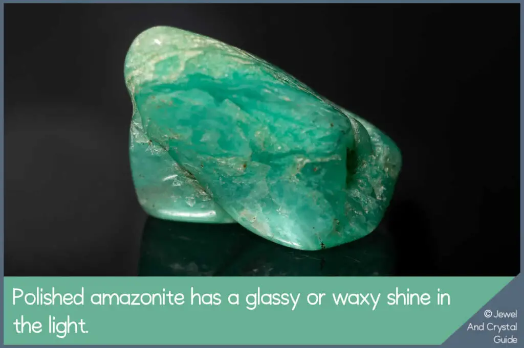 Photo of light shining on amazonite crystal to show the waxy or glassy shine of a real crystal